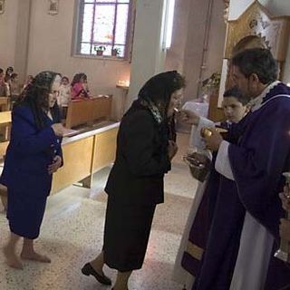Palestinian Christians receiving communion