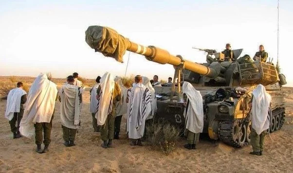 Israeli soldiers praying before entering Gaza